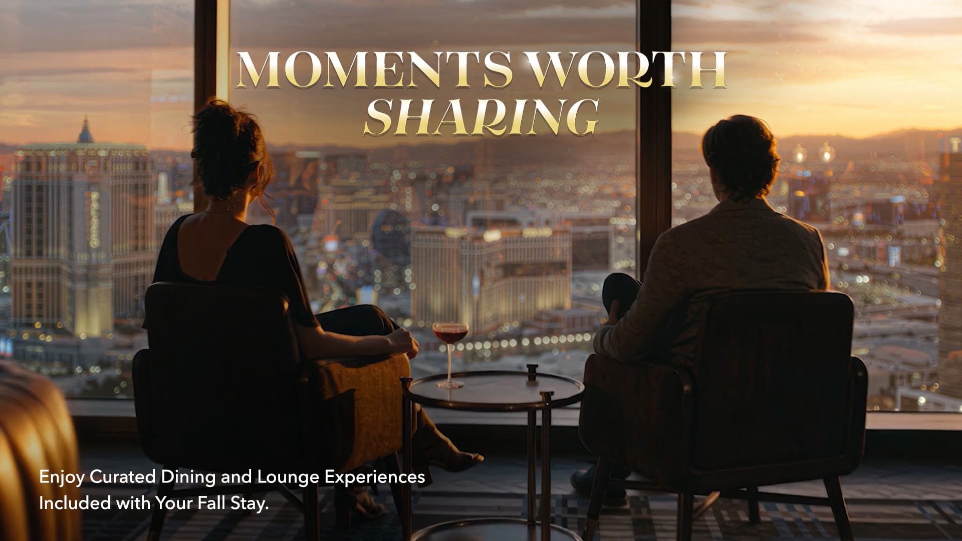 Two guests overlooking the Las Vegas Strip at sunset with text promoting curated dining and lounge experiences included with a fall stay.