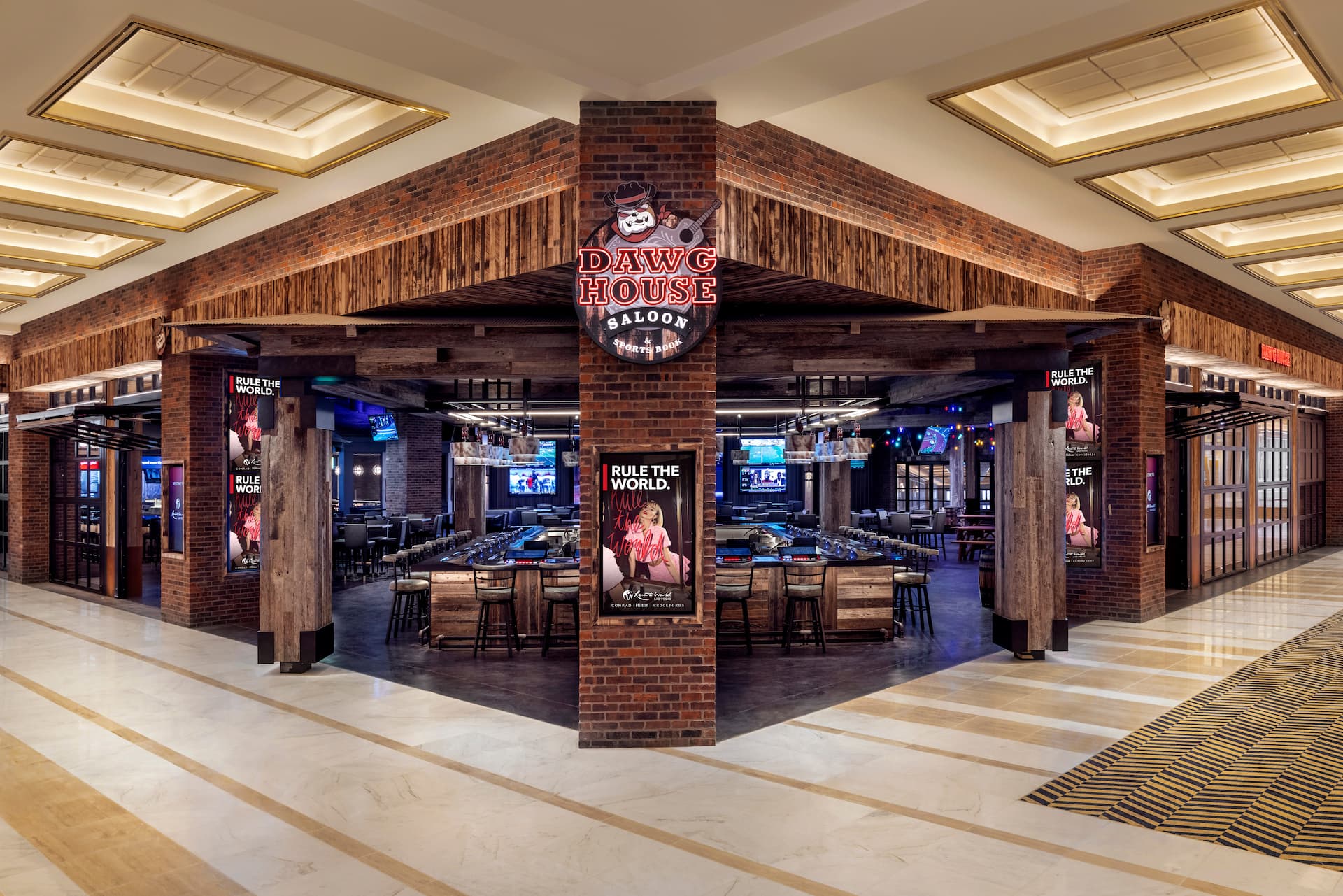 Entrance to Dawg House Saloon featuring rustic wood and brick architecture with an open bar and seating area inside.